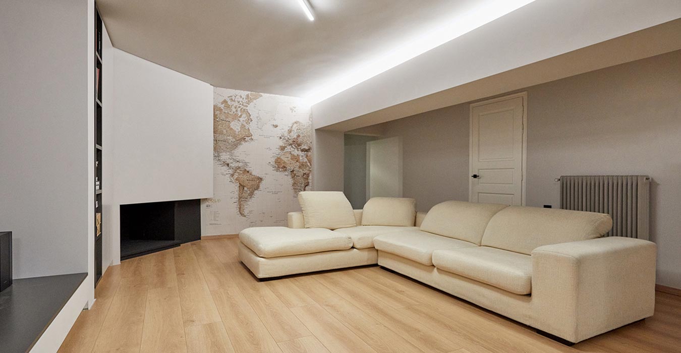 Living room interior with fireplace structure and a world map wallpaper.