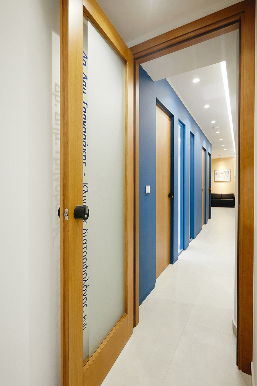 The accent blue wall has vertical windows and oak doors