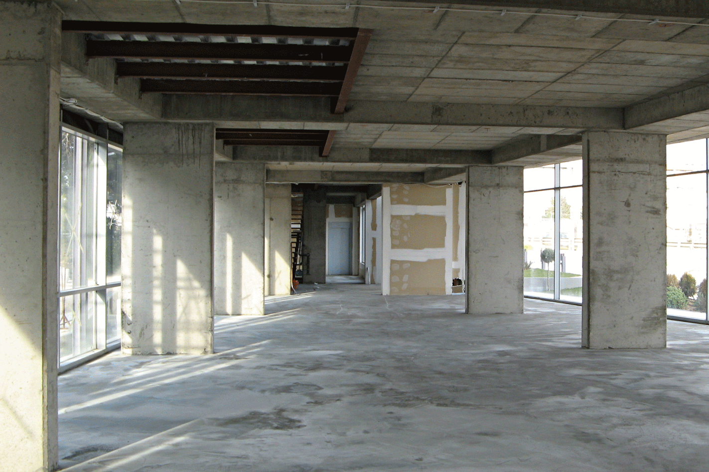 Construction stages showing the initial building shell and the elaborated finished interior space