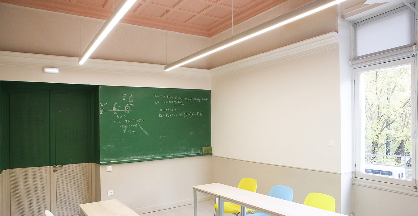 Green blackboard extents from one corner of the wall to the other.