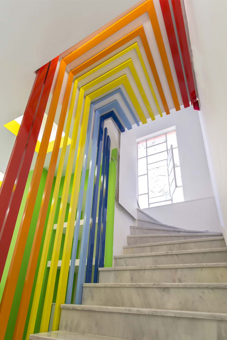 Custom-made stair railing becomes the colorful background for the reception